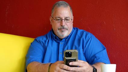 Tony Godwin using a smartphone