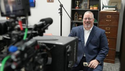 Tony Godwin smiles as he sits in front of a camera about to do an interview for Predator Hunters