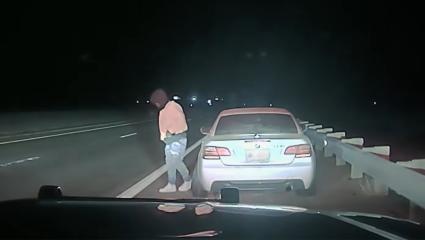 Police dashcam footage of a motorist exiting their vehicle