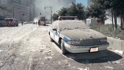 A NYPD car covered in debris and ash, following the 9/11 terrorist attacks