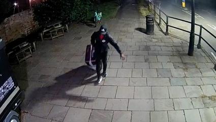 CCTV of Yostin Andres Mosquera wheeling a suitcase across the bridge