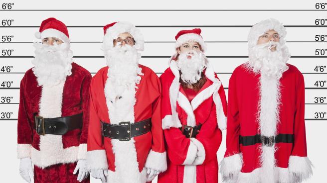 Four people dressed as Santa in a police line up
