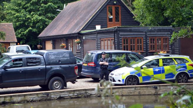 Police cars outside John Palmer's home in Essex following his murder