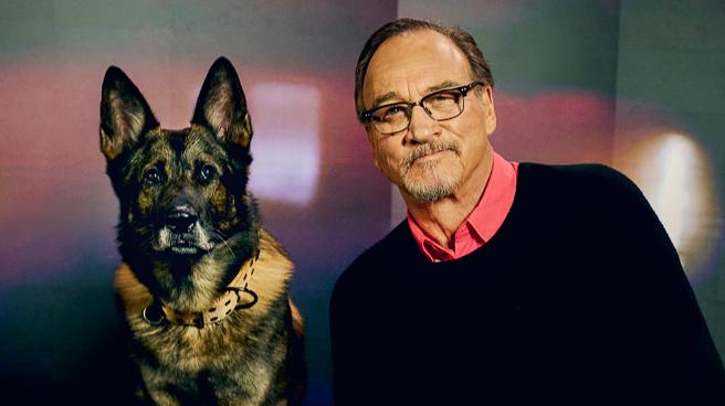 Jim Belushi with a police dog