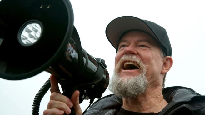 Flash Shelton uses a megaphone