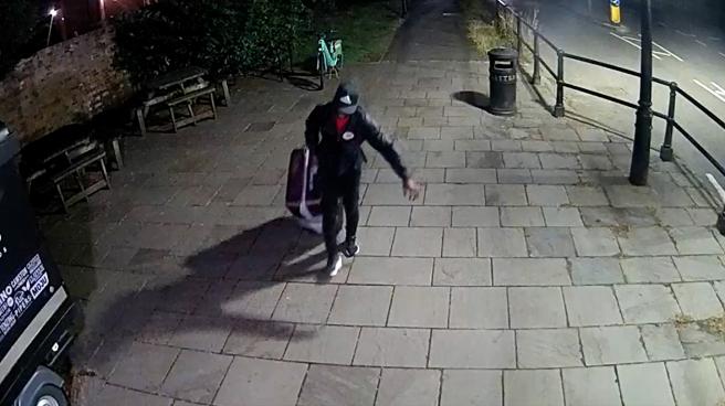 CCTV of Yostin Andres Mosquera wheeling a suitcase across the bridge