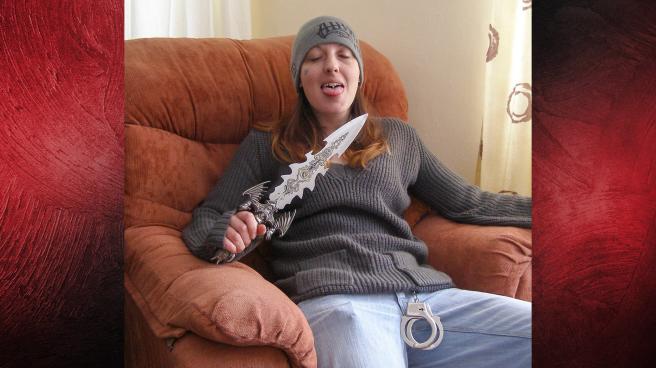 Joanna Dennehy sitting in a chair holding a very large knife