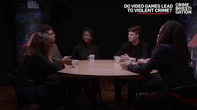 Students sitting around a table discussing if video games lead to violent crime