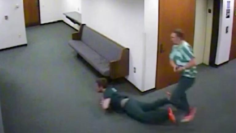 CCTV footage of two convicts running through a corridor and one has fallen over
