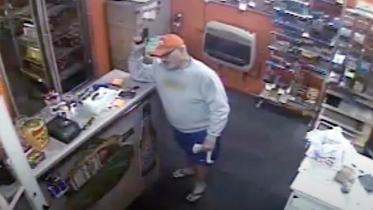 CCTV footage of a shopkeeper to holding a handgun