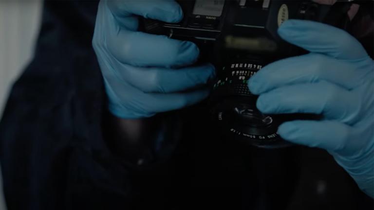 A crime scene photographer takes an photograph