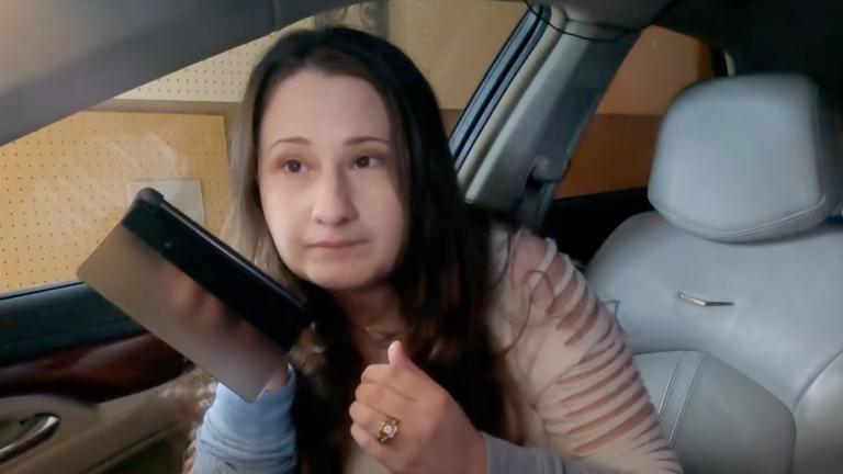 Gypsy Rose Blanchard using her phone on loudspeaker while sitting in the passenger seat of a car