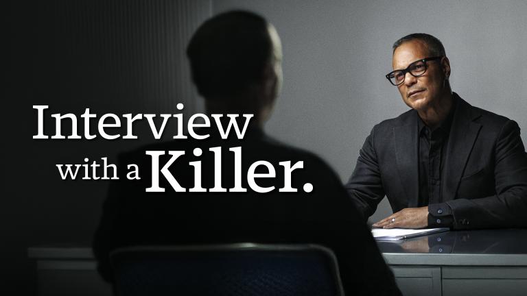 David Scott sitting in an interview room with an anonymous killer with his back to the camera