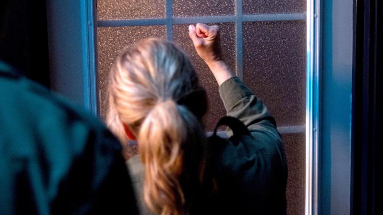 A woman knocking aggressively on a front door