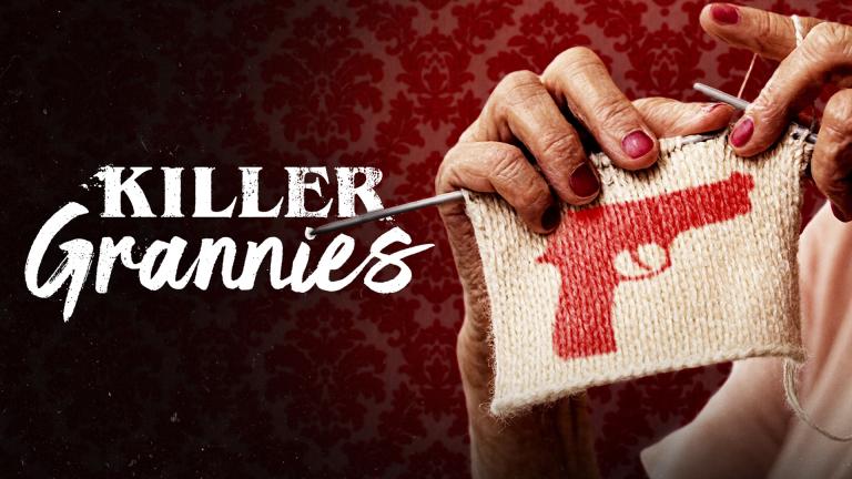 A granny knitting a red gun pattern on a white square