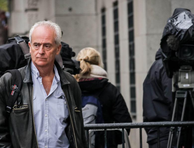 Nick Davies arrives at the Old Bailey court in London - surrounded by news cameras