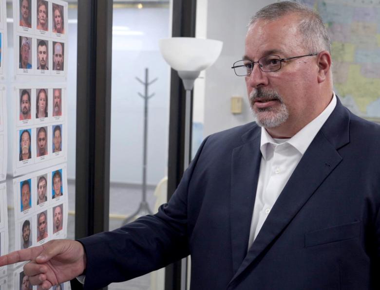 Detective Tony Godwin pointing at an evidence board