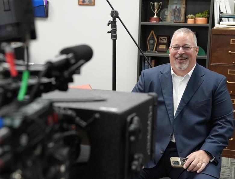 Tony Godwin smiles as he sits in front of a camera about to do an interview for Predator Hunters
