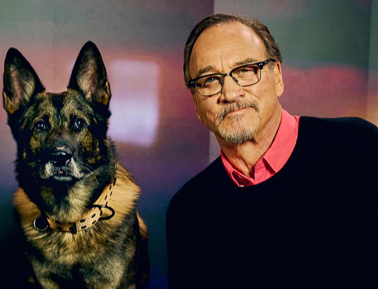 Jim Belushi with a police dog