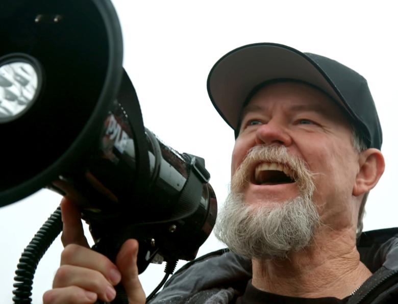 Flash Shelton uses a megaphone