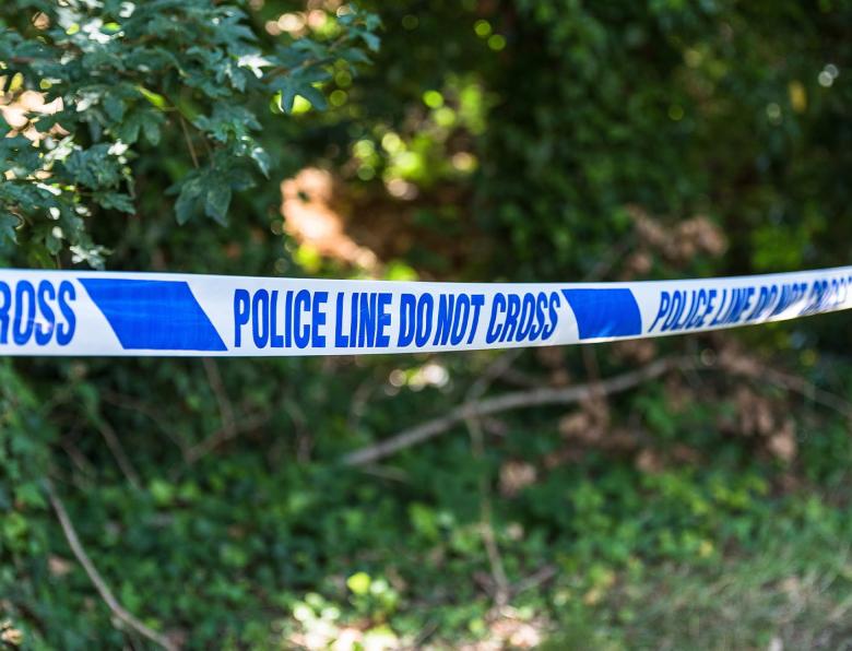 Police tape in a park