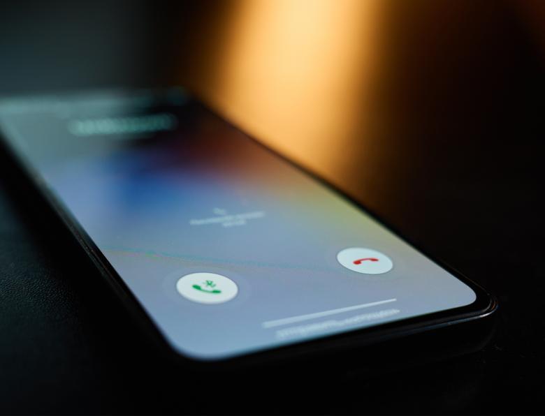 A smartphone lighting up as it receives a phone call