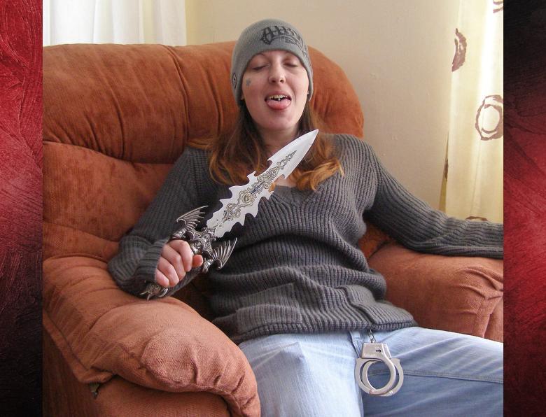 Joanna Dennehy sitting in a chair holding a very large knife