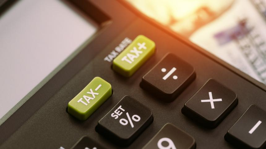 A photograph of a calculator with tax buttons