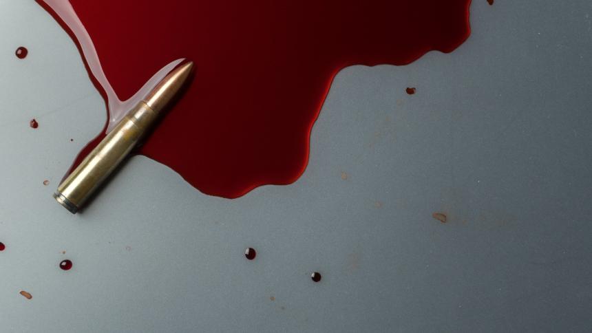 A stock photograph concept of a bullet in fake blood
