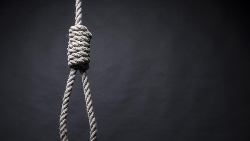 A photograph of gallows on a black background