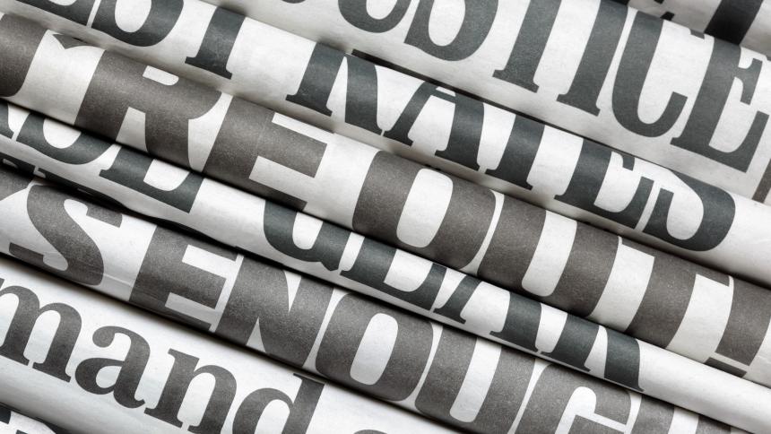 A stock photo of folded newspapers. 