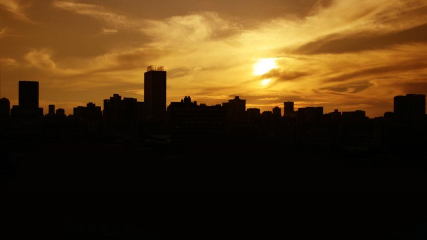 A photograph showing the city skyline silhouette of Johannesburg, South Africa