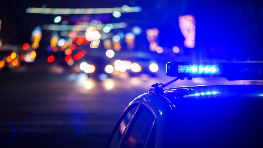 A stock photograph showing police lights in a generic city at night