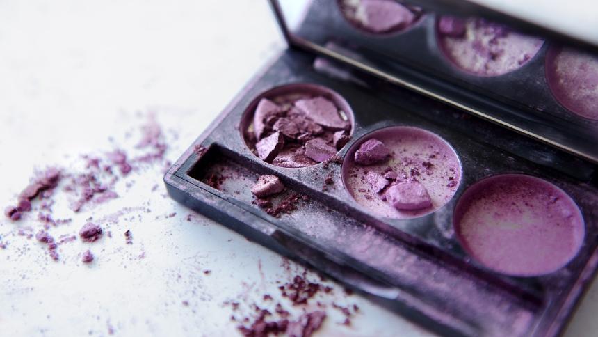 A photograph showing broken purple eye shadow