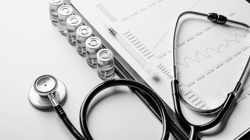 A stock photo showing a doctors stethoscope and analysis documents.
