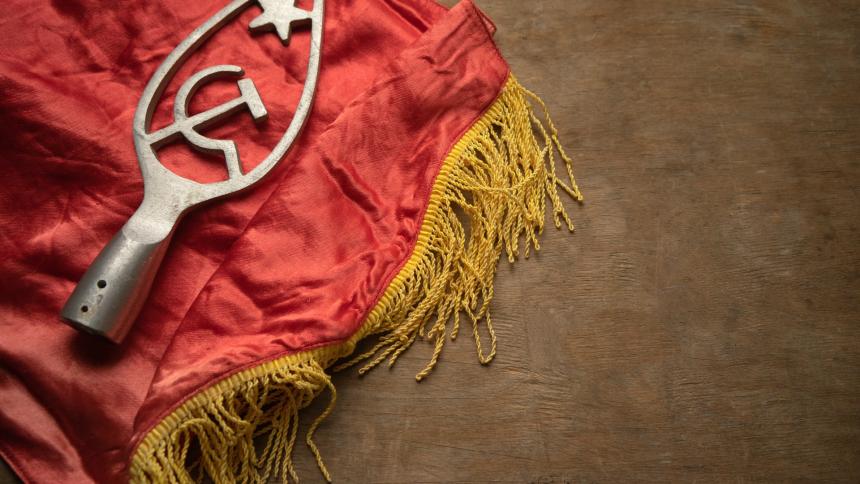 A photograph of a red flag with yellow tassels, from the Soviet Union. Symbols of communism.