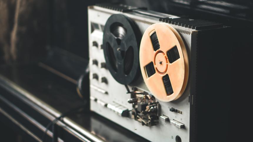 A photograph of a retro wiretapping technique, using a reel to reel tape recorder. 