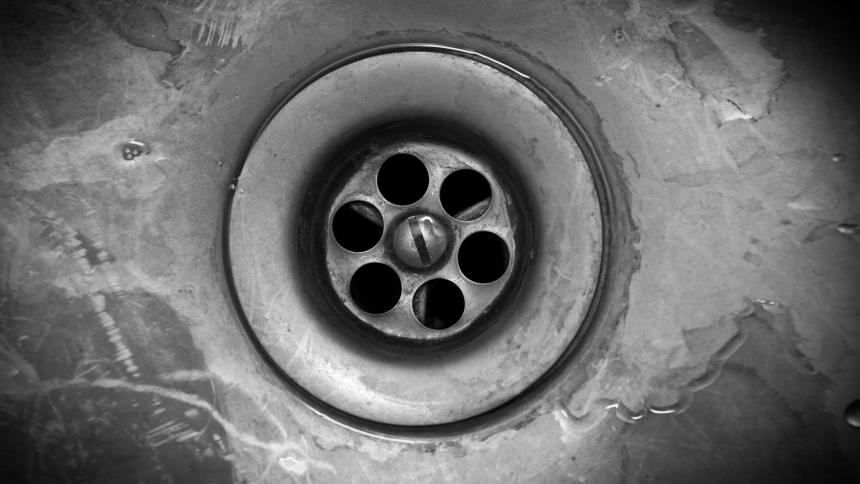 A photograph of a dirty drain.