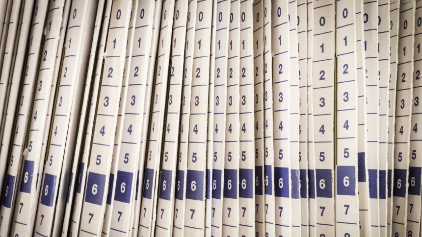 A stock photograph showing rows of files in a medical office.