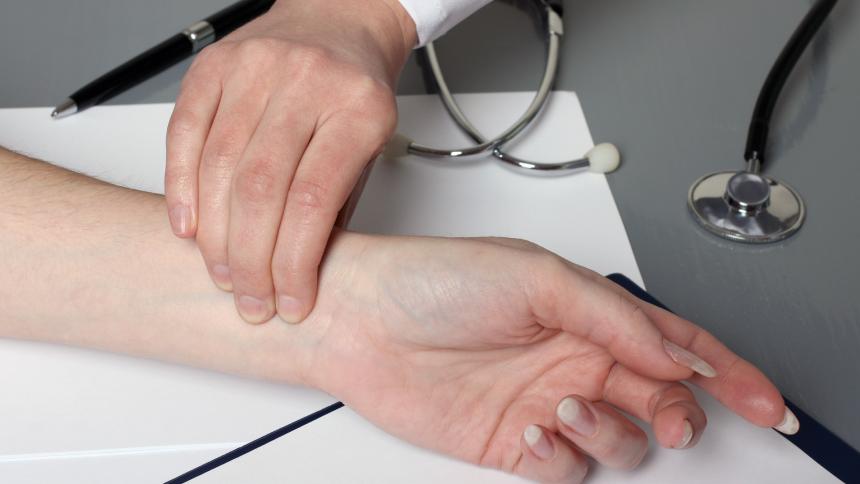A stock photo of a doctor measuring a patient's pulse.