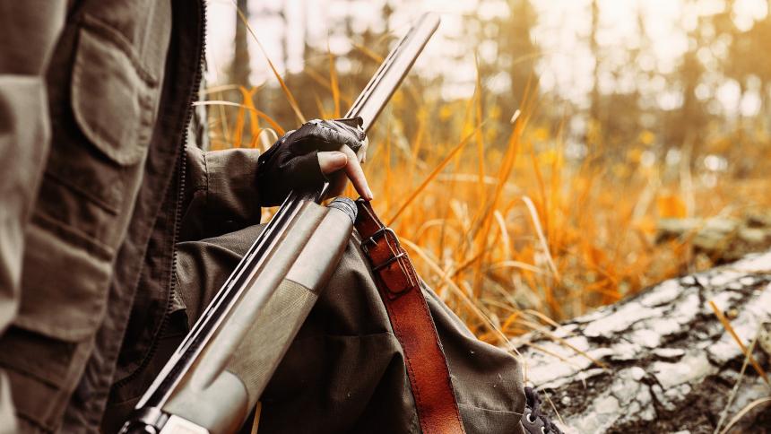 A stock photograph of a person hunting in the woods