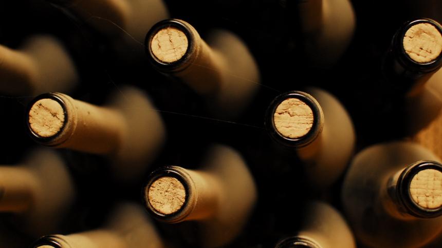 A photograph showing corks in bottles of alcohol.