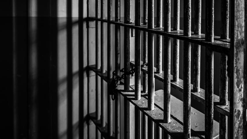 A photograph showing metal bars in a jail