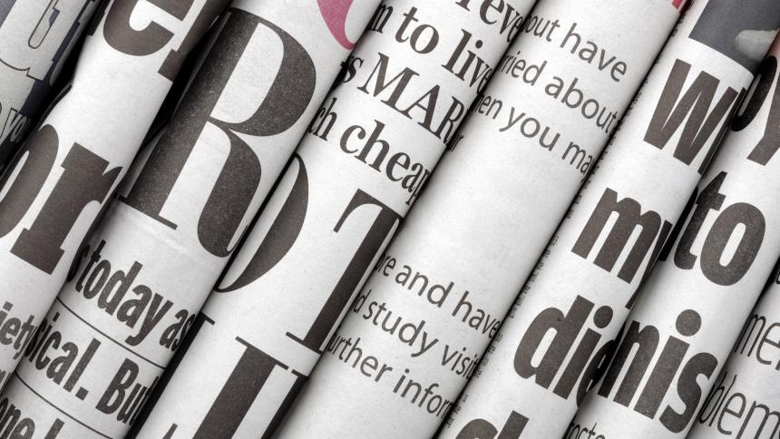 A stock photo showing multiple newspapers