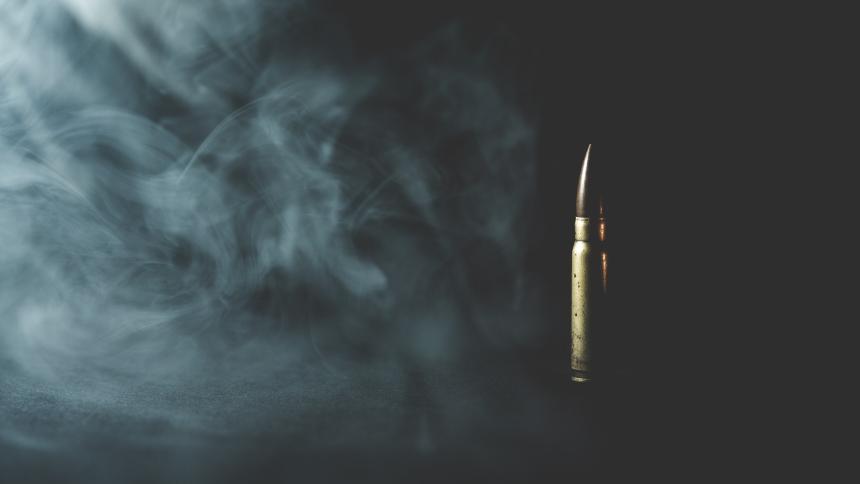 A stock photo showing a bullet surrounded by smoke