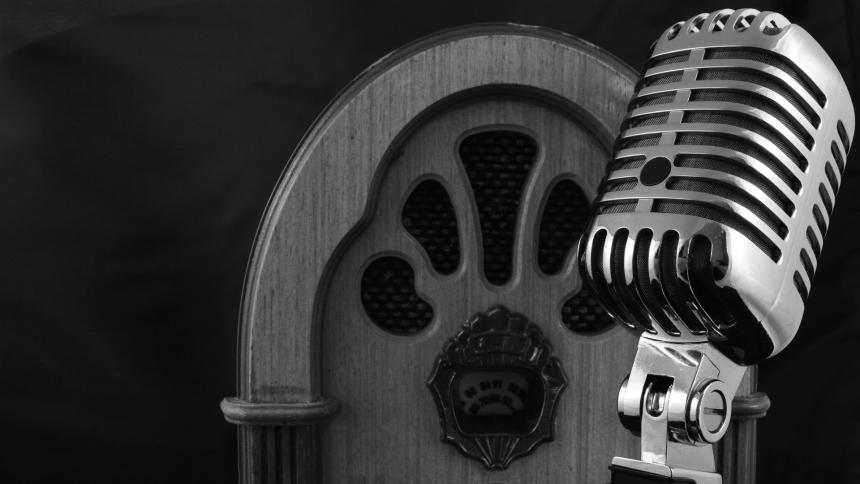 A stock photo showing a retro radio and broadcast microphone