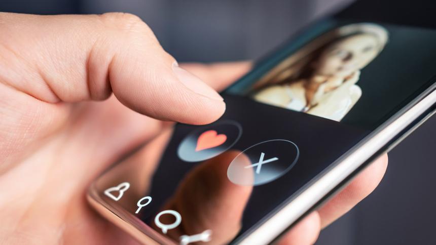 A man using a dating app on a smart phone