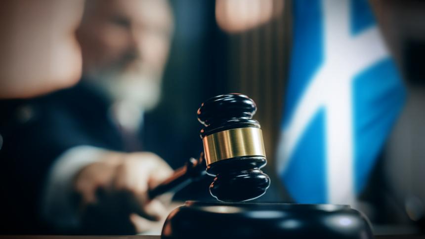A stock image fictional depiction of a courtroom and the Flag of Scotland