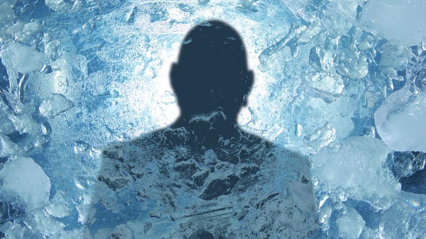 A silhouette of a person behind frozen ice