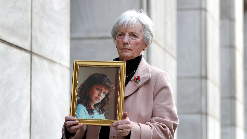 Marie McCourt, mother of Helen McCourt, holds an image of her daughter outside court